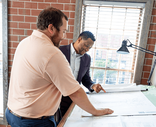 Two Business men discussing building plans downtown